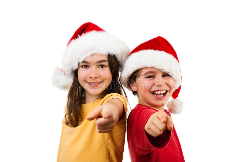 Tiempo de la Navidad - muchacha y muchacho con Santa Claus Hat que muestra la muestra ACEPTABLE foto de archivo libre de regalías Tiempo de la Navidad - muchacha y muchacho con Santa Claus Hat que muestra la muestra ACEPTABLE foto de archivo libre de regalías