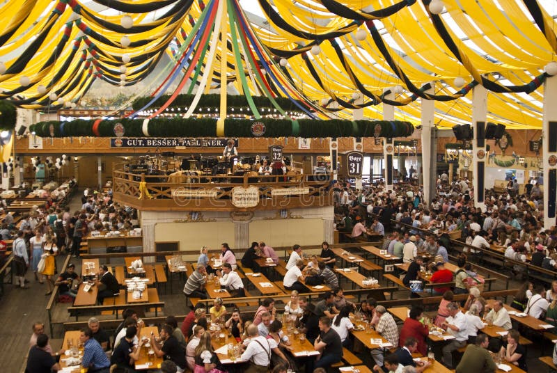 Indoor picture of the Paulaner tent with people drinking and eating - Oktoberfest / Wiesn - beer fest - Munich, Germany 2009. Indoor picture of the Paulaner tent with people drinking and eating - Oktoberfest / Wiesn - beer fest - Munich, Germany 2009