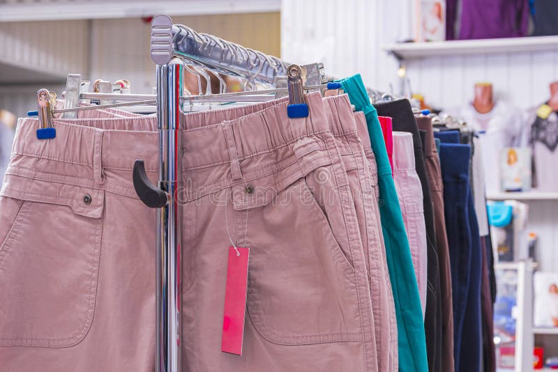 Tienda De Ropa Para Mujeres. Una Colección De Pantalones De Mujer Colgada En Un De Metal. Gran Elección. Imagen de archivo - Imagen de ropas, mercado: 198297069