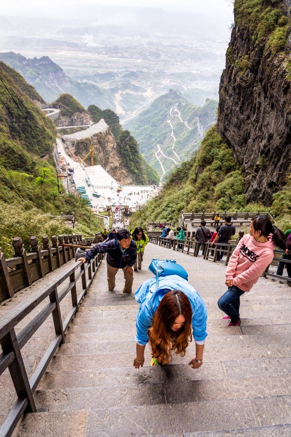 Tiered tourists climbing 999 stairs to Haven Gate in Tianman Mountains royalty free stock photo Tiered tourists climbing 999 stairs to Haven Gate in Tianman Mountains royalty free stock photo