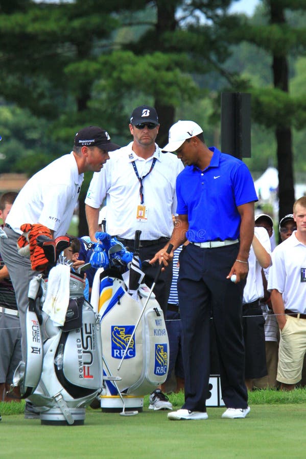 Tiger Woods discusses strategy with his partner at the PGA professional golf tournament event, Northeast Ohio, United States. Tiger Woods discusses strategy with his partner at the PGA professional golf tournament event, Northeast Ohio, United States