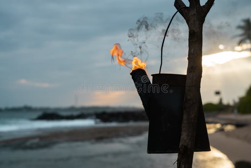 Tiki torches with a bright orange Hawaiian sunset stock photo Tiki torches with a bright orange Hawaiian sunset stock photo