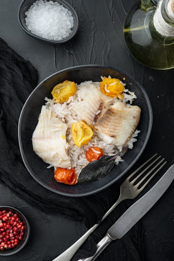 Tilapia Fish with Basmati Rice and Cherry Tomatoes in Bowl, on Black