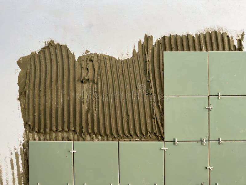 Tile Adhesive is Applied To the Wall for Laying Ceramic Tiles