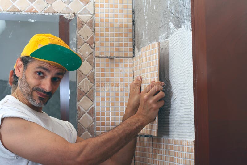 Tile adhesive installation stock image. Image of artisan 25082605