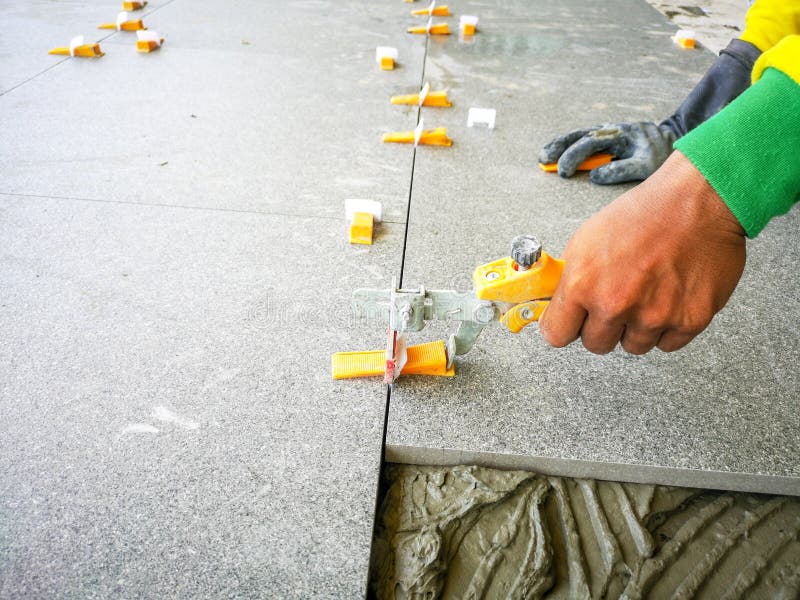 Tile Work Placing Ceramic Floor Tile in with Lash Tile Leveling System