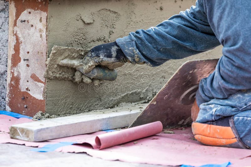 Tile Worker Applying Cement with Trowel at Pool Construction Site Stock