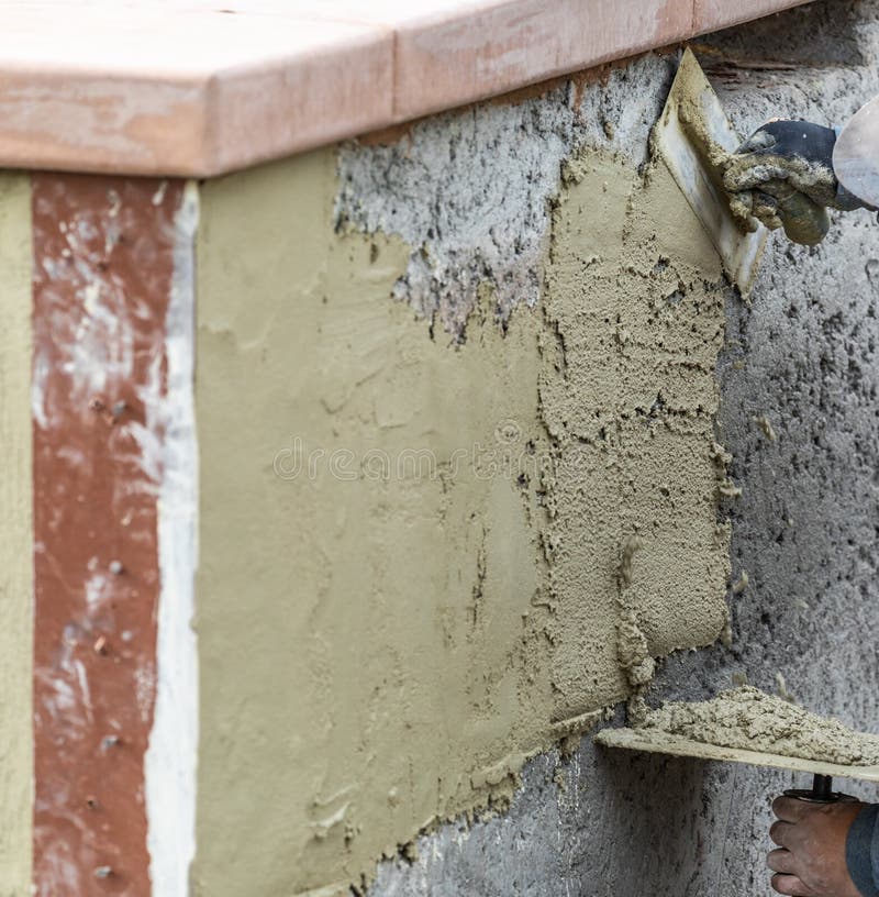Tile Worker Applying Cement with Trowel at Pool Construction Site Stock