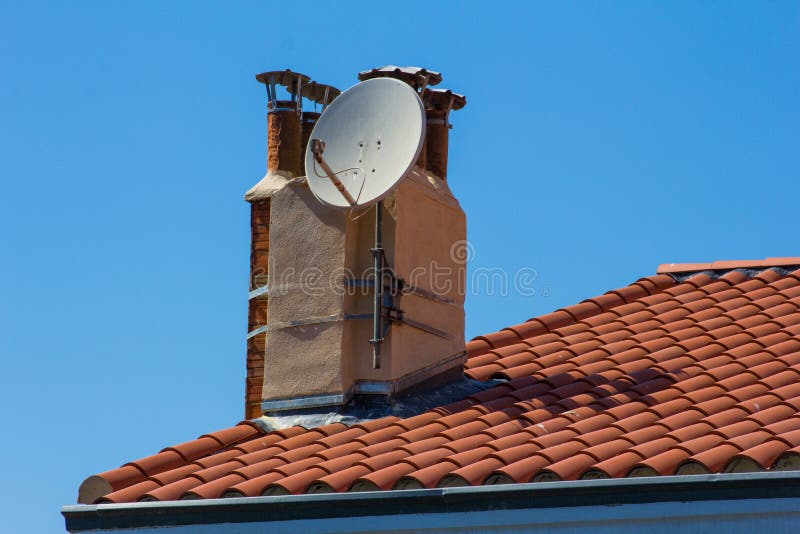 TV Antenna on the Tiled Roof of a House with Dormer Stock Photo Image