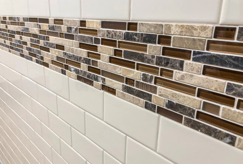 Tiles made of glass and stone installed on the wall as decoration or kitchen backsplash