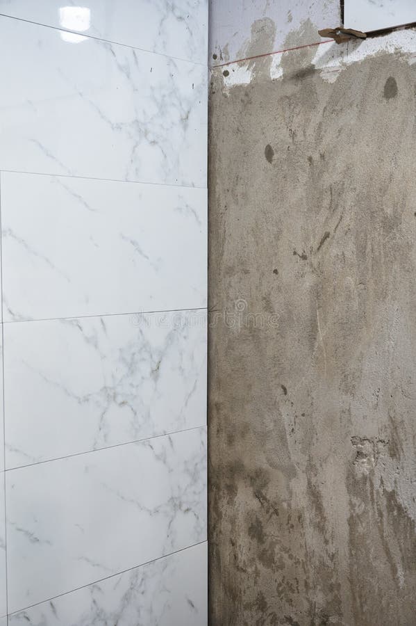 Tiling and Renovation with Marble Ceramic Tile on Cement Wall in the