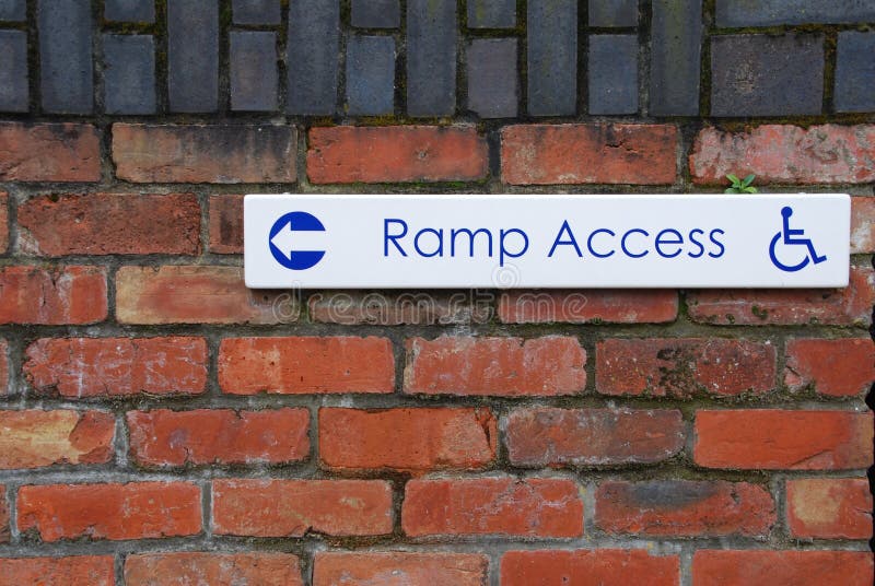 Ramp access sign on a brick wall background. Ramp access sign on a brick wall background