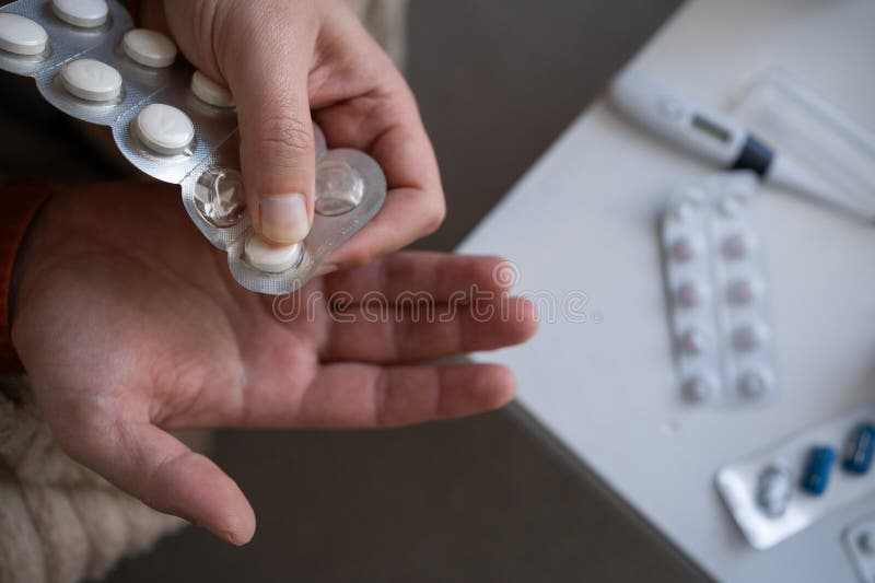 Close-up of a man taking pills from a blister. Flu and cold treatment disease concept. Copy space. Close-up of a man taking pills from a blister. Flu and cold treatment disease concept. Copy space