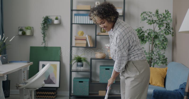 Tilt Down Portrait Of Cheerful African American Woman Washing Floor