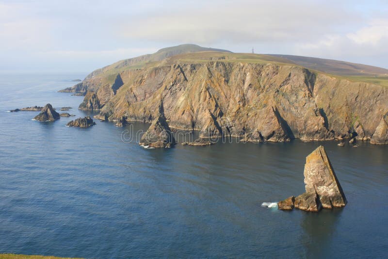 Tilted triangular strata in sea cliffs