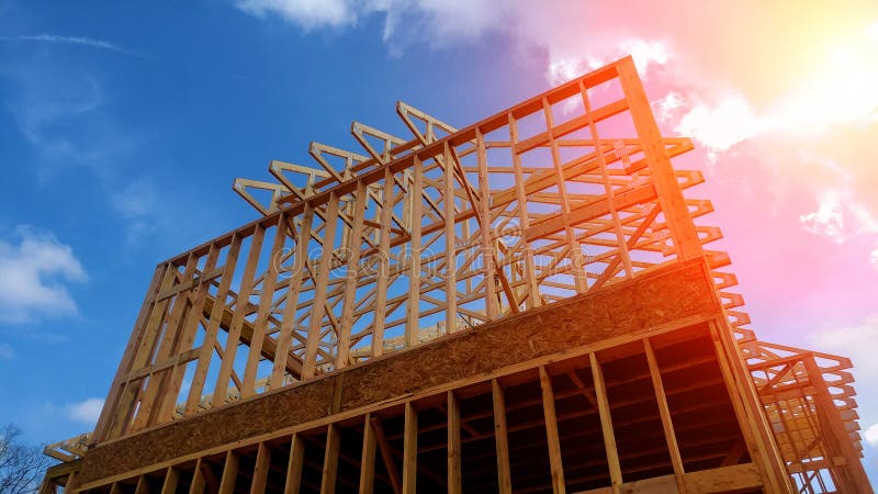 Timber frame house, new build roof with wooden truss, post and beam framework home construction framing. Timber frame house, new build roof with wooden truss, post and beam framework home construction framing