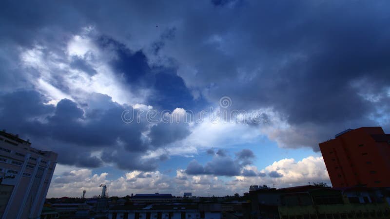 Time lapse of cloudy sky over roofs