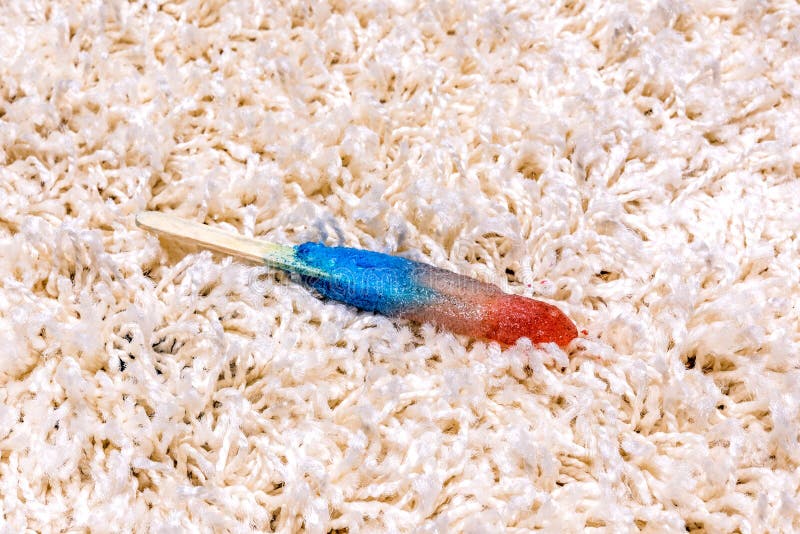 A time lapse of a melting popsicle on white carpet shows the icy treat melt into a sticky juice and absorb right into the carpet. A time lapse of a melting popsicle on white carpet shows the icy treat melt into a sticky juice and absorb right into the carpet.