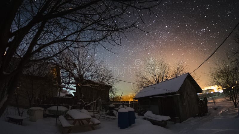 Time lapse of the starry sky in the winter garden