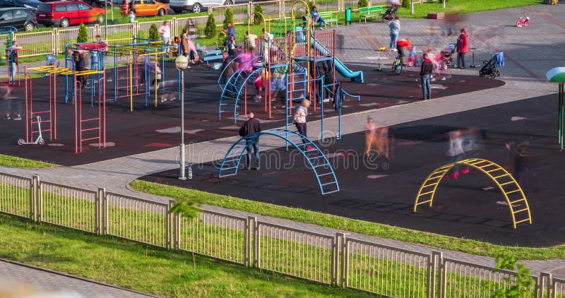 Time lapse with a view of the playground with a lot of parents with children