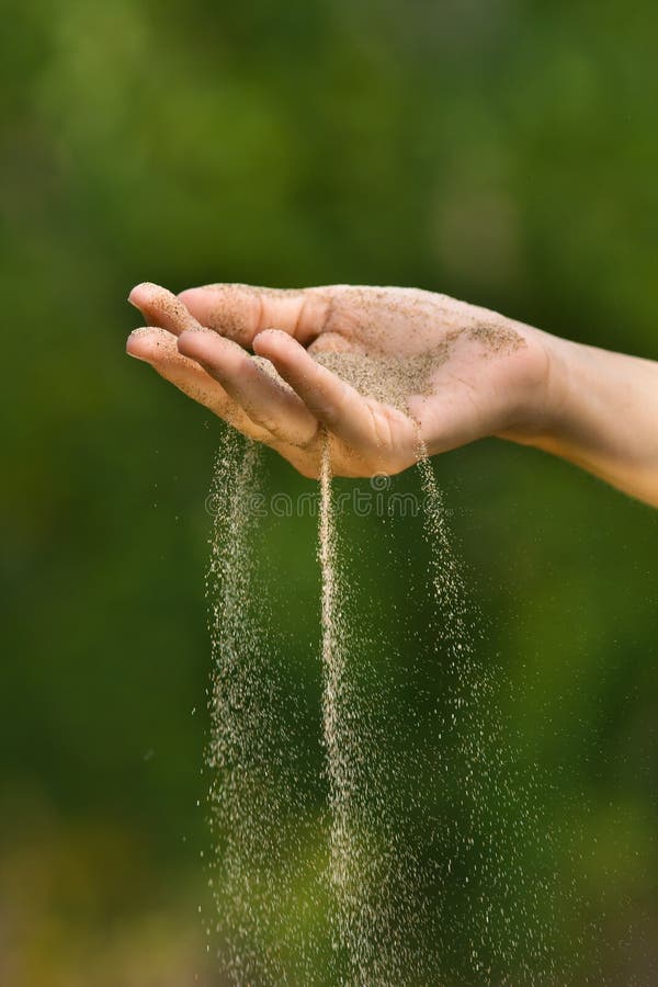 Sand Running through Hands of Woman Stock Image Image of female