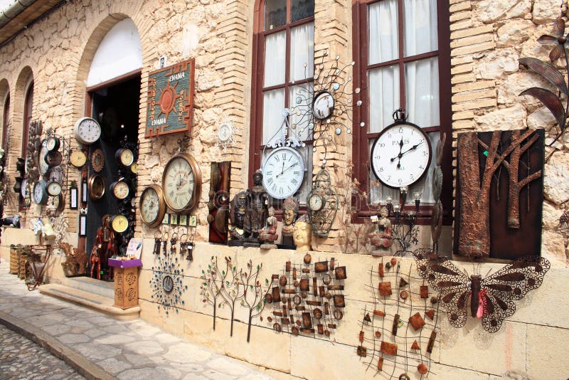 This photo was taken in Guadalest, the most visited village in the Valencia region of Spain. It is of a clock and souvenir shop and has a surrealist Dali flavour. This photo has not been enhanced or Photoshoped in any way. Looks great with a warmer or slight sepia tint. Also has a wonderfully old fashioned feel in black and white with slightly increased contrast. Contrast enhanced stock images, royalty-free photos and pictures