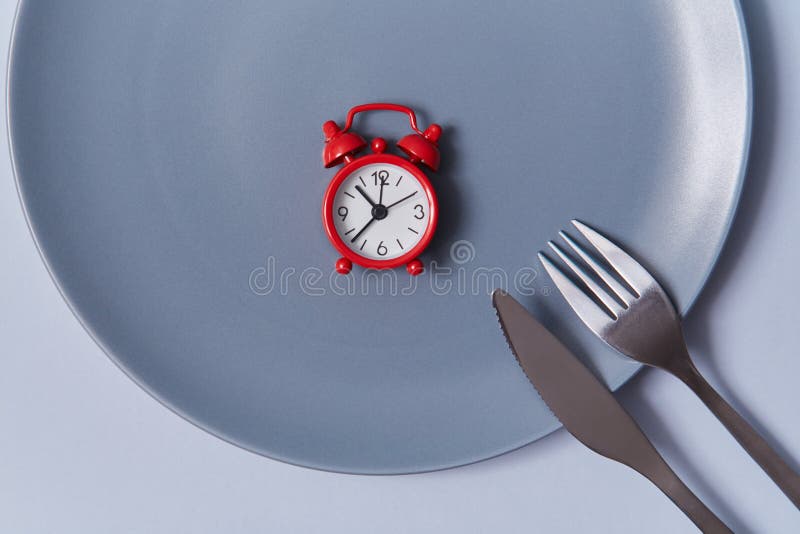 Time To Eat Background. Top View of Red Alarmclock in Empty Table with Knife and Fork. Isolated