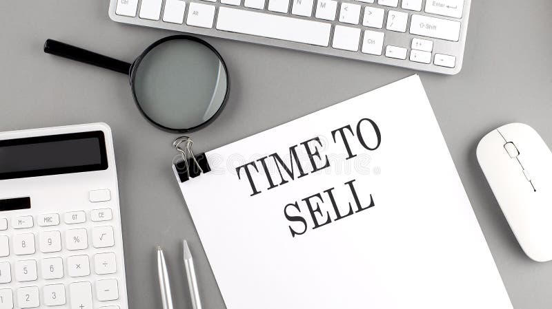 TIME TO SELL written on a paper with office tools and keyboard on the grey background. Keyboard sell stock images, royalty-free photos and pictures