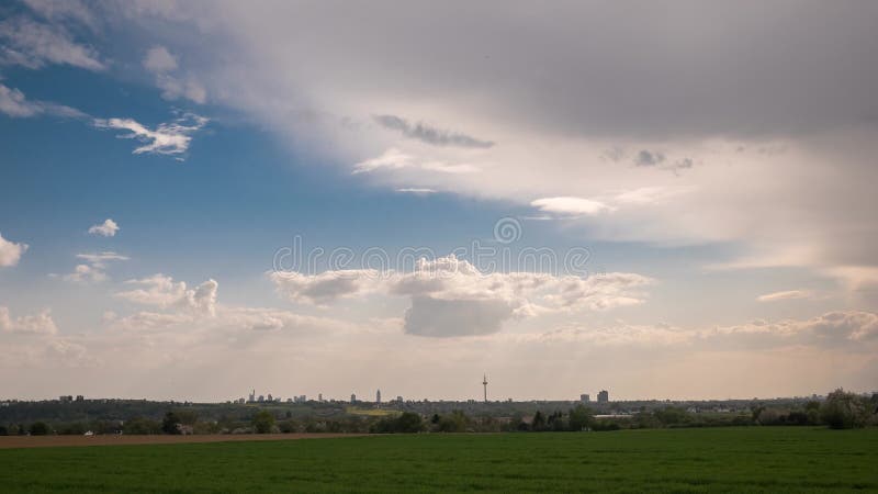Timelapse - Moving clouds over a field in spring stock video footage
