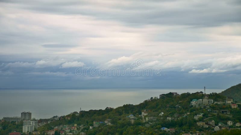 Timelapse moving clouds over the sea coast at sunset stock footage