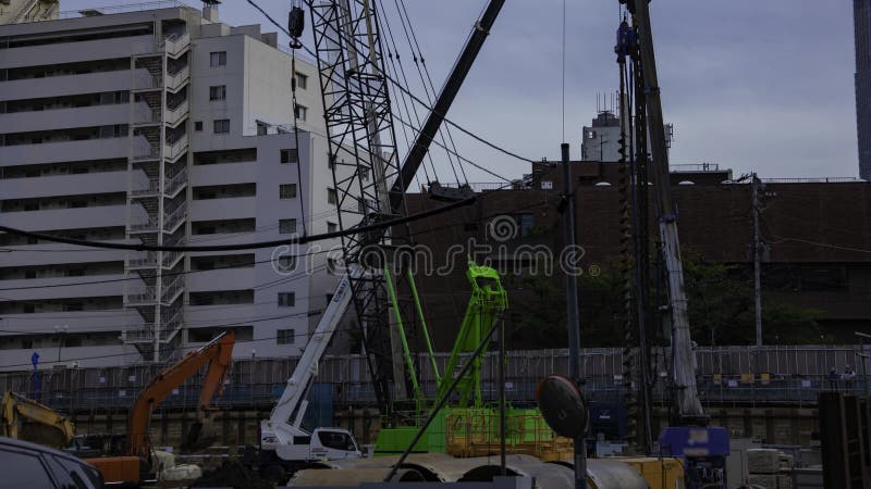 A timelapse of moving crane at the under construction in Tokyo panning stock video footage