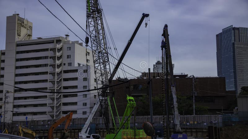 A timelapse of moving crane at the under construction in Tokyo tilt stock video