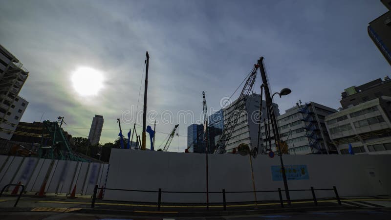 A timelapse of moving crane at the under construction in Tokyo wide shot stock video footage