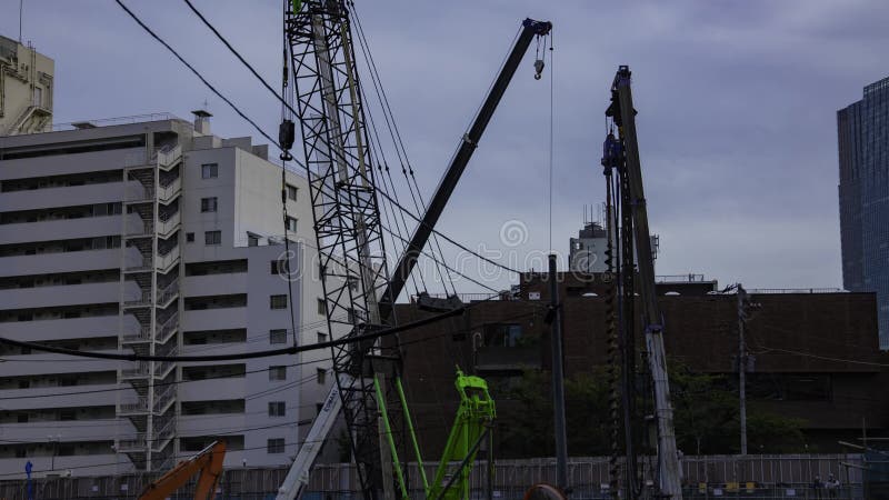 A timelapse of moving crane at the under construction in Tokyo zoom stock video