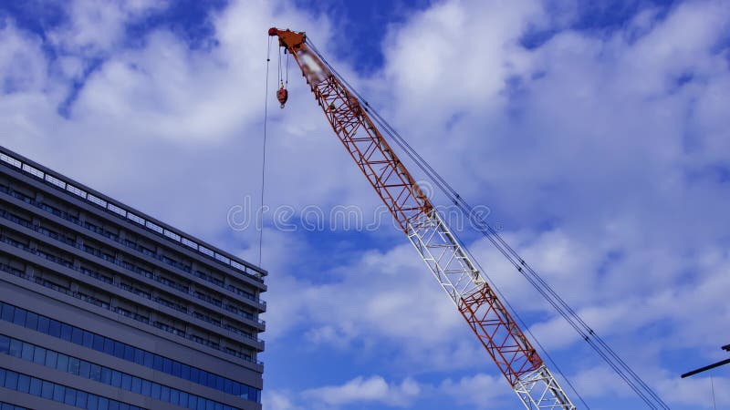 A timelapse of moving cranes at the under construction in Tokyo panning stock footage