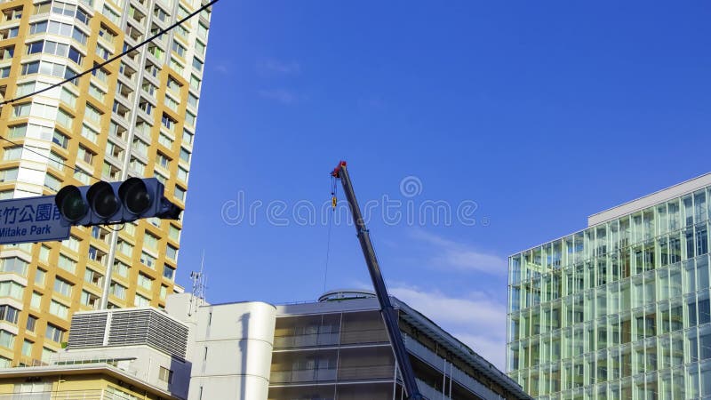 A timelapse of moving cranes at the under construction in Tokyo panning stock video footage