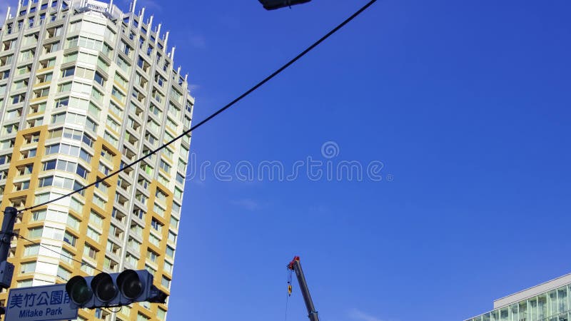 A timelapse of moving cranes at the under construction in Tokyo panning stock video footage