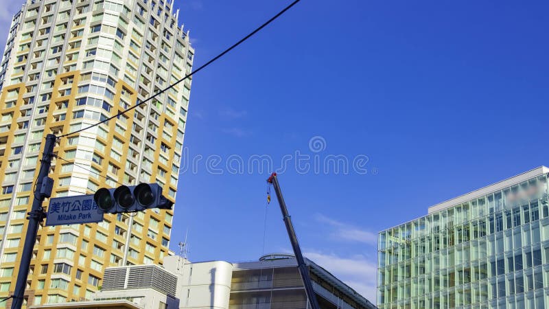 A timelapse of moving cranes at the under construction in Tokyo tilt stock video footage