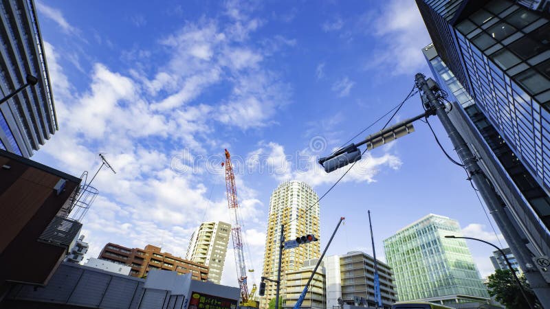 A timelapse of moving cranes at the under construction in Tokyo wide shot stock video footage