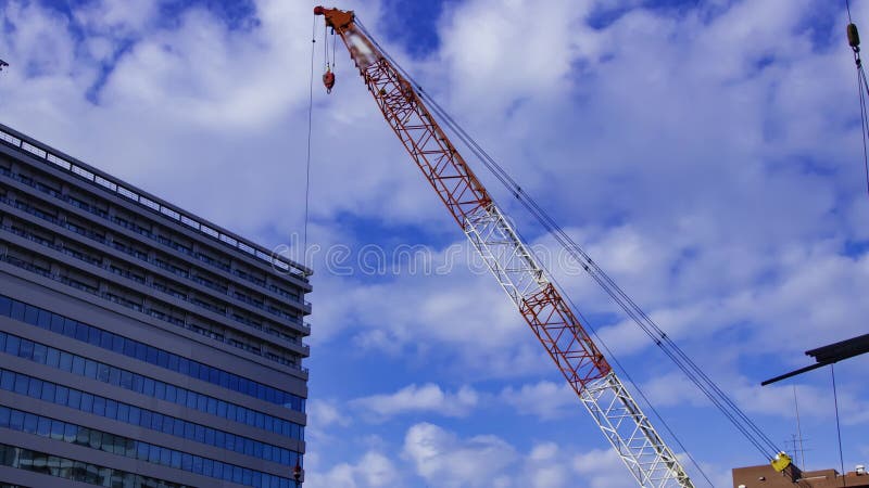 A timelapse of moving cranes at the under construction in Tokyo zoom stock footage