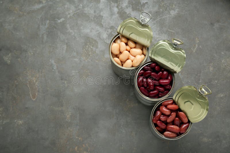 Tin Cans with Different Canned Kidney Beans on Grey Table, Flat Lay
