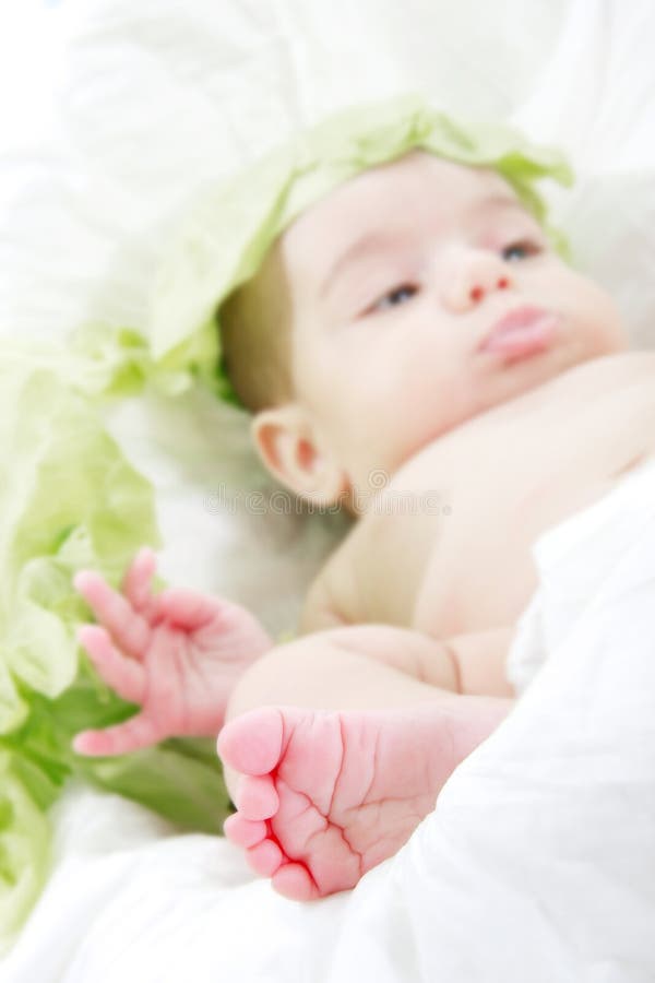 Tiny baby s foot, baby in cabbage