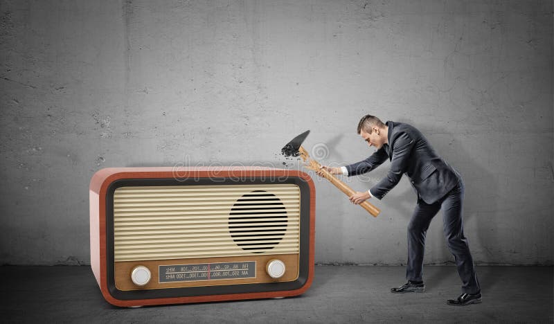 vervangen tsunami Blind A Tiny Businessman on Concrete Background Tries To Destroy a Large Retro  Radio Set with a Broken Hammer. Stock Image - Image of media, power:  103549543