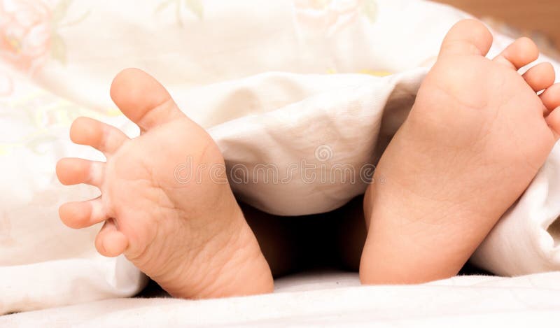 Baby feet under a blanket stock photo. Image of pink - 29706364