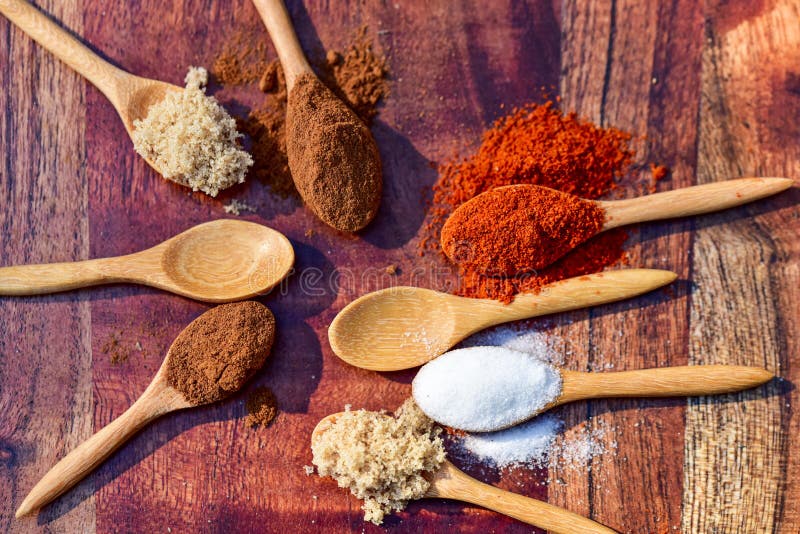 Tiny Wooden Spoons Filled with Sugars and Spices on Cutting Board Stock  Photo - Image of cinnamon, kitchen: 231789508