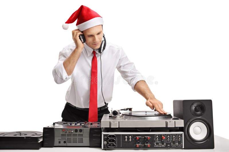 Tipo formalmente vestito che porta un cappello di natale e che gioca musica immagine stock libera da diritti Tipo formalmente vestito che porta un cappello di natale e che gioca musica immagine stock libera da diritti