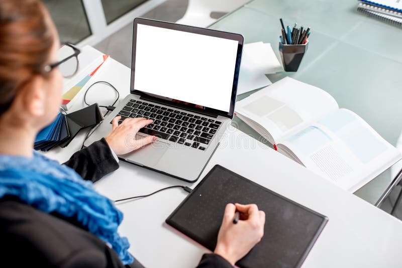 Woman drawing on the digital board and laptop with empty screen to copy paste in the office. Woman drawing on the digital board and laptop with empty screen to copy paste in the office