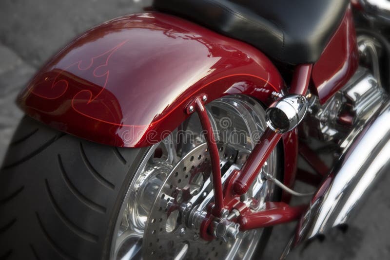 Close Up Motorcycle Tire, Red Fender, and Exhaust Pipe