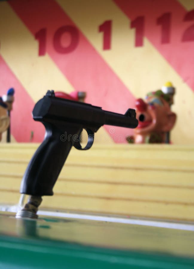 Gun aimed at clown/shoot the clown carnival game. Gun aimed at clown/shoot the clown carnival game