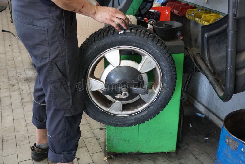 Car Mechanician Changing Tire Car Wheel in Auto Repair Shop Editorial